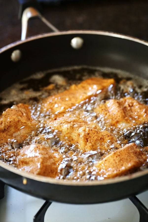 Fish frying in a skillet.