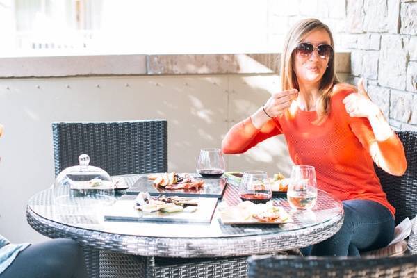 girl sitting at a table outside