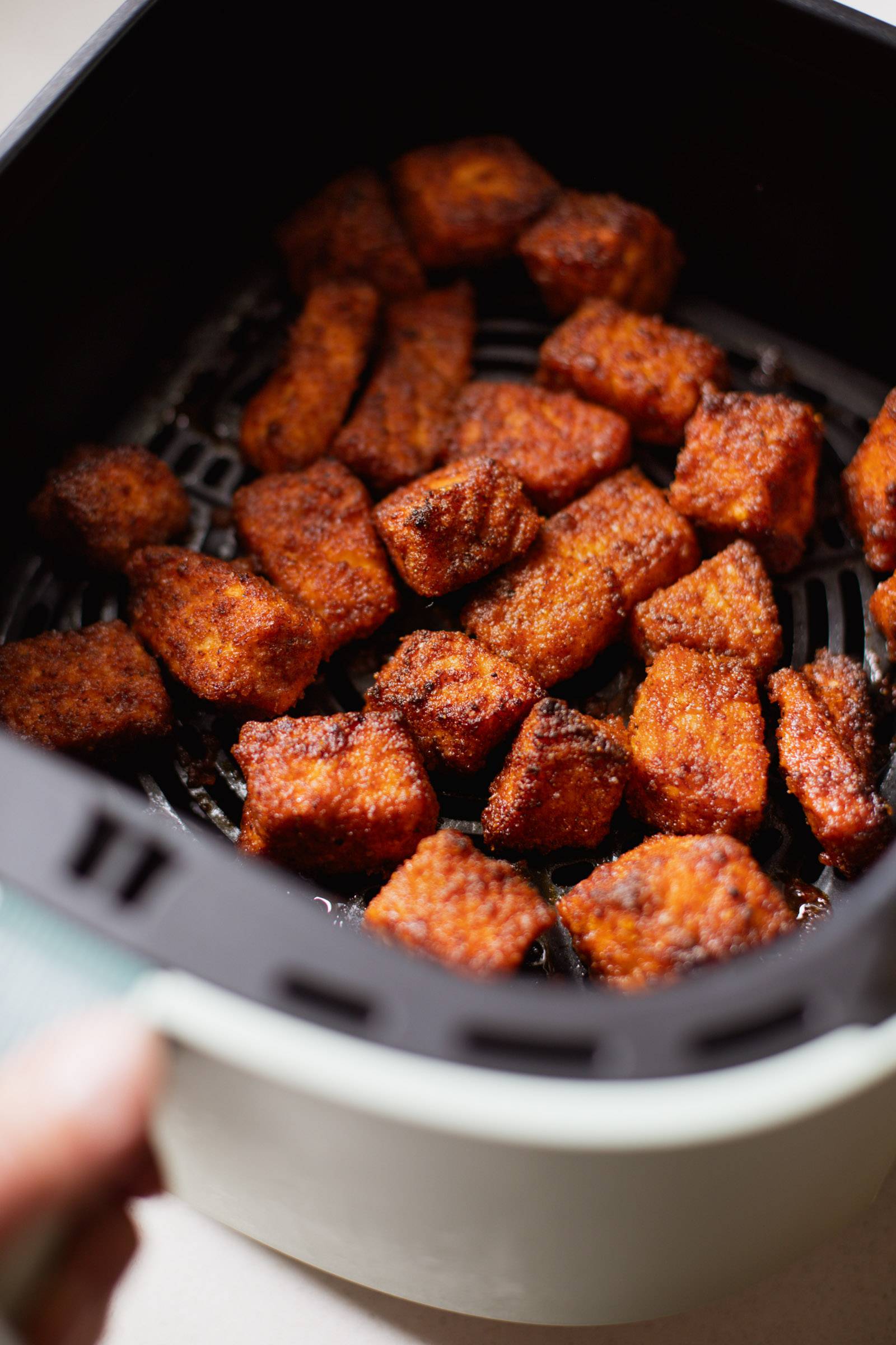 Air fryer salmon in an air fryer basket.