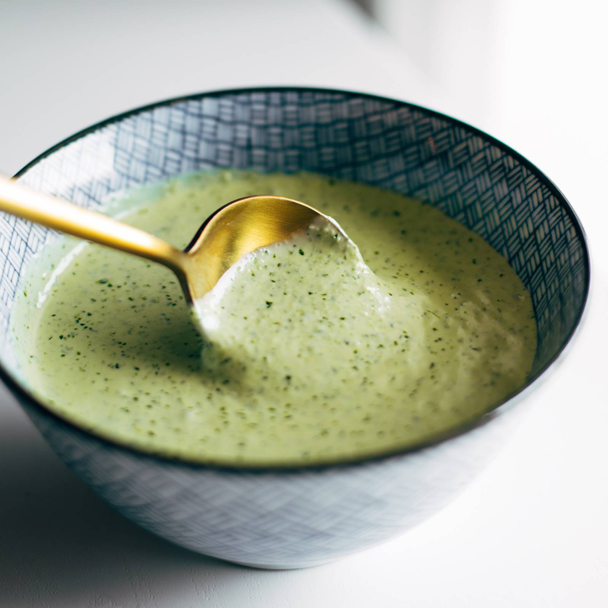 Aji verde in a bowl with a spoon.