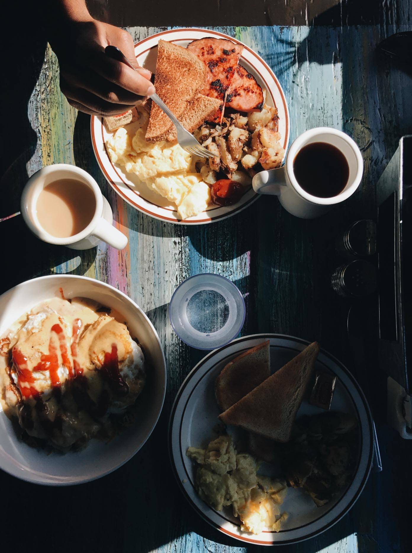 Table with plates of breakfast food.