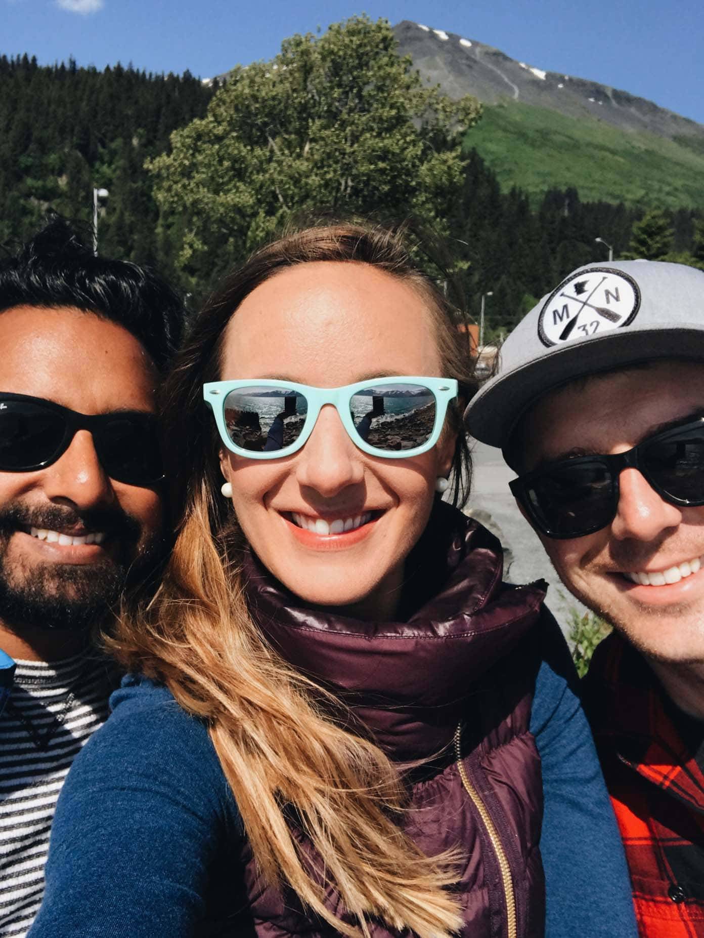 Three people wearing sunglasses.