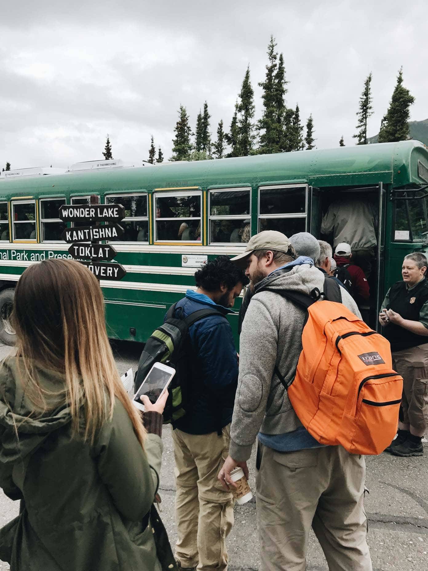 People getting on to a bus.