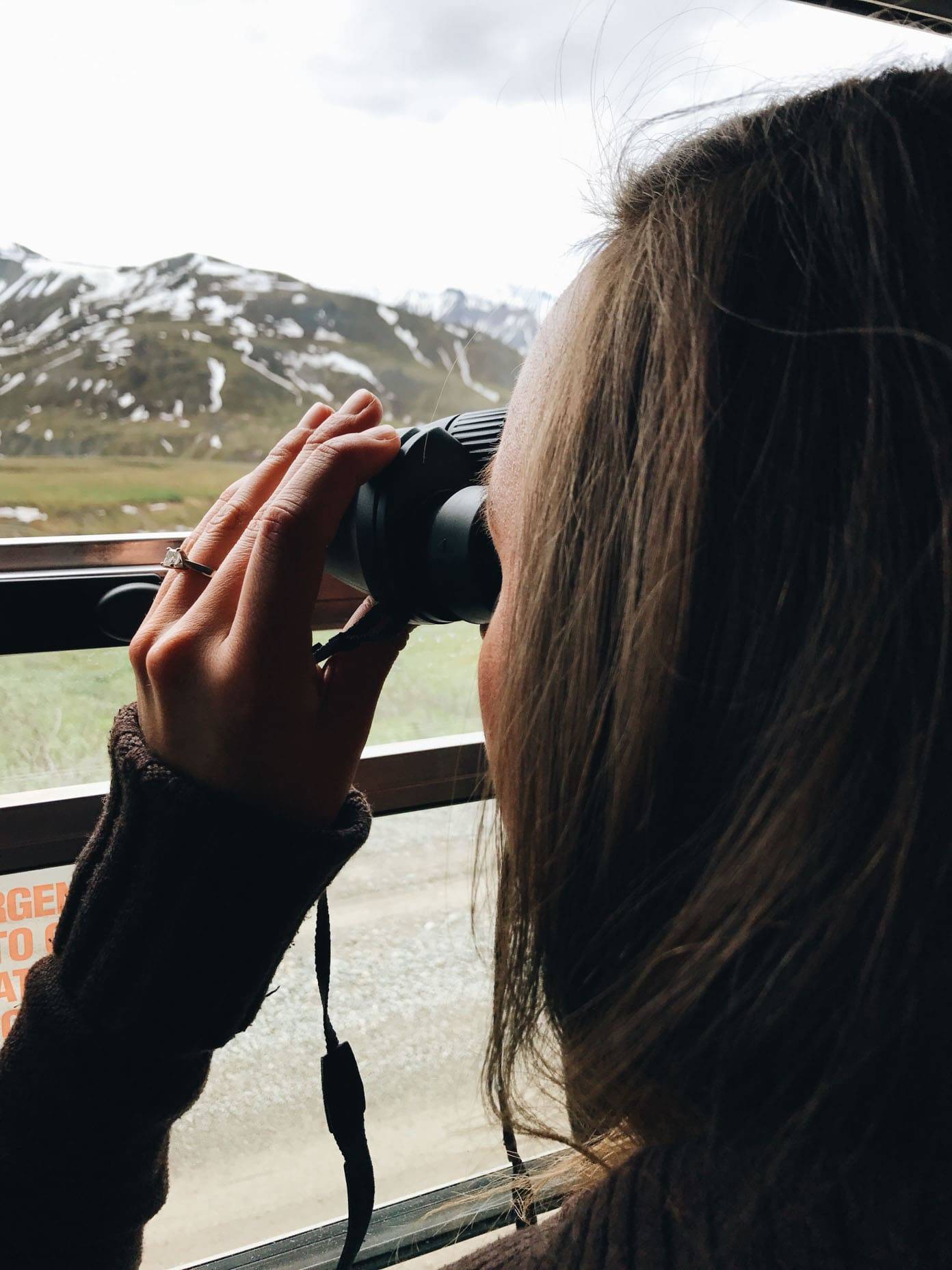 Woman using binoculars.