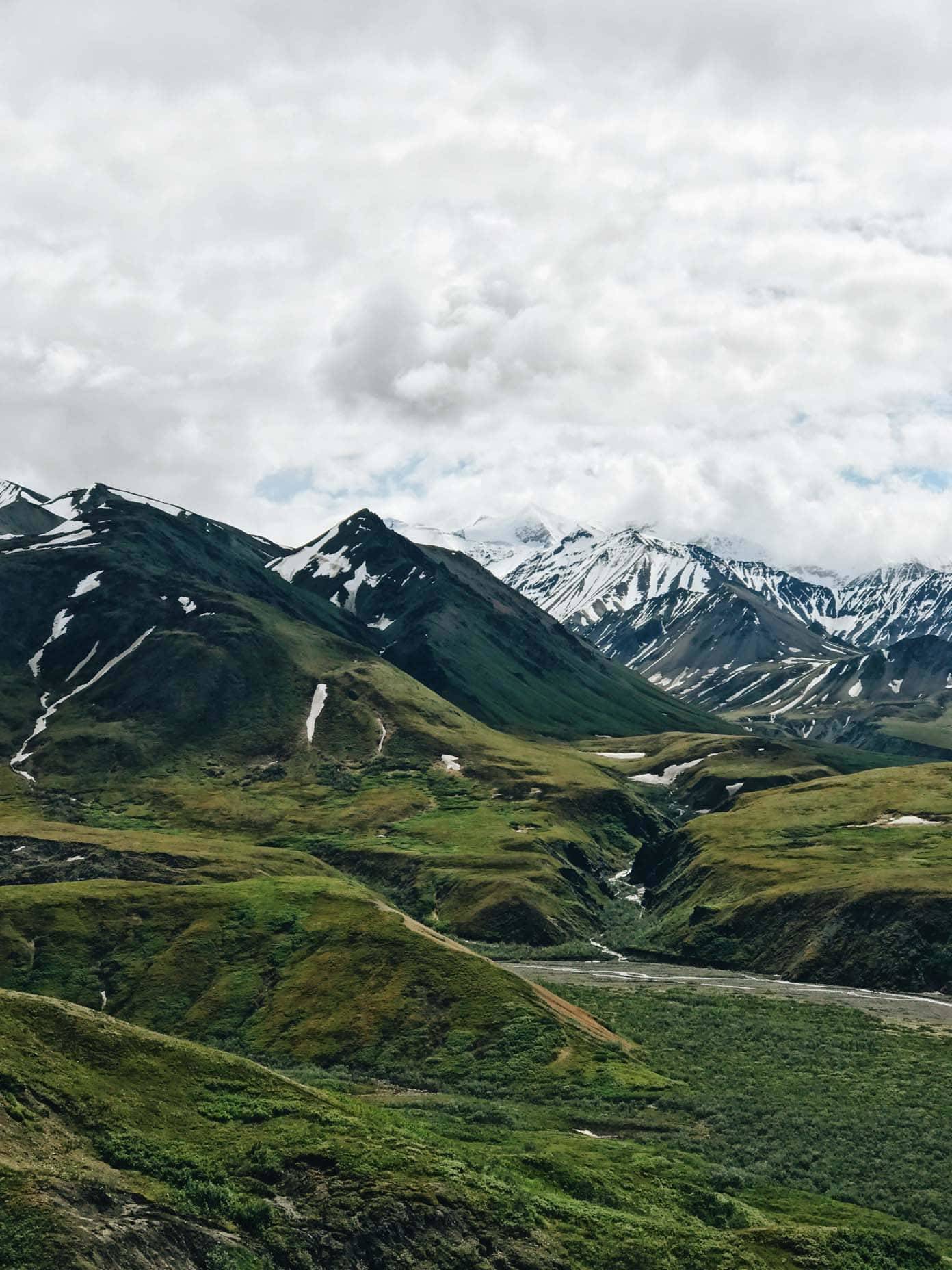 Grassy and snowy mountains.