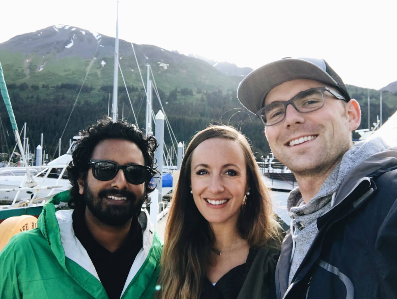 Three people near boats.