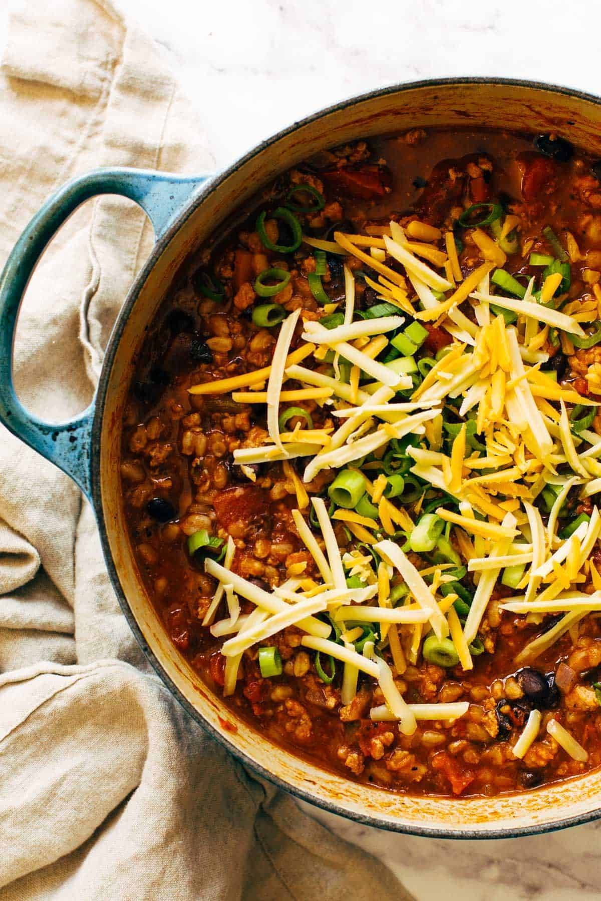 Ancho Turkey Chili in a pot with toppings.