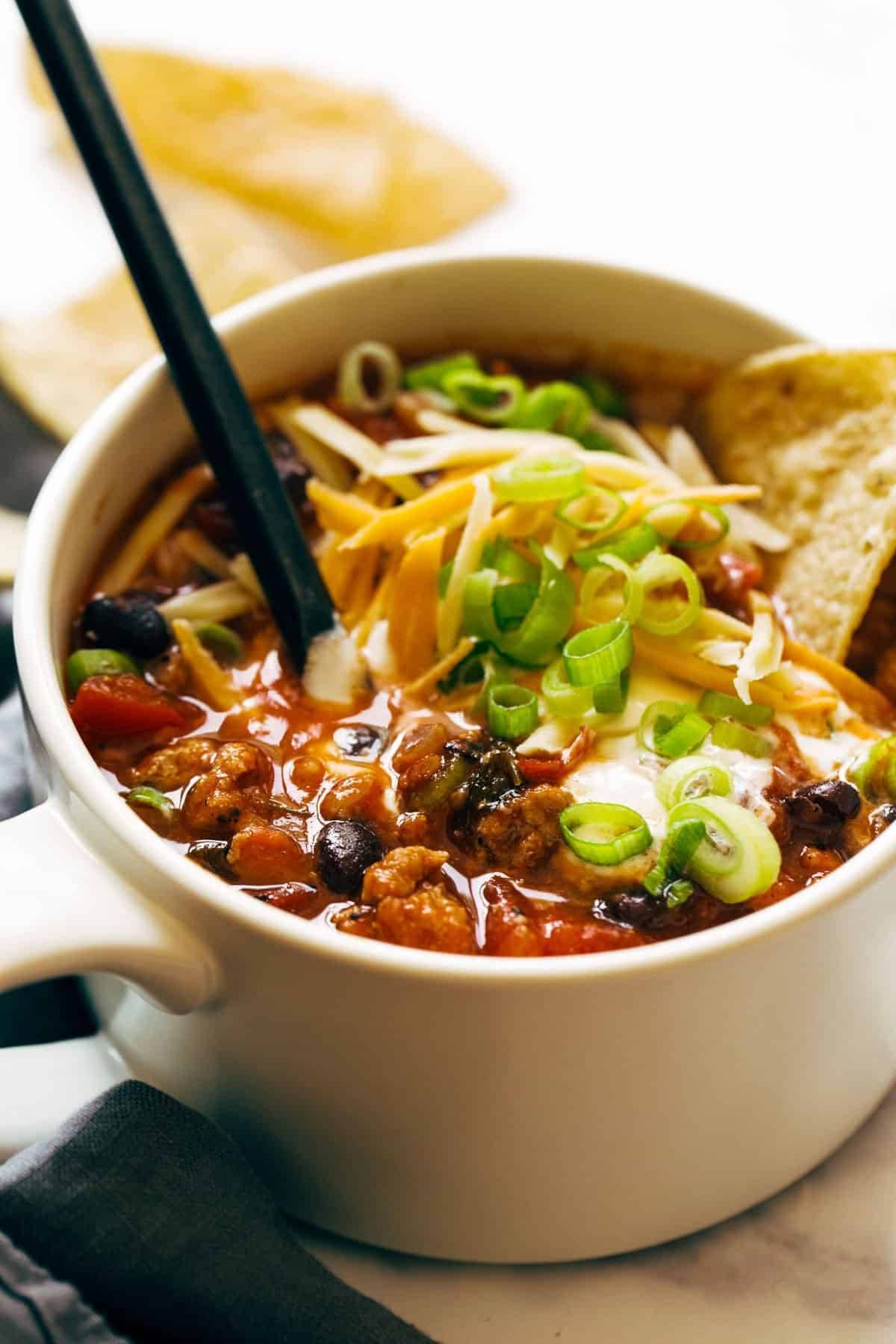 Ancho turkey chili in a bowl with toppings.