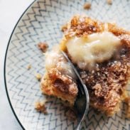 A fork cuts into apple cake.