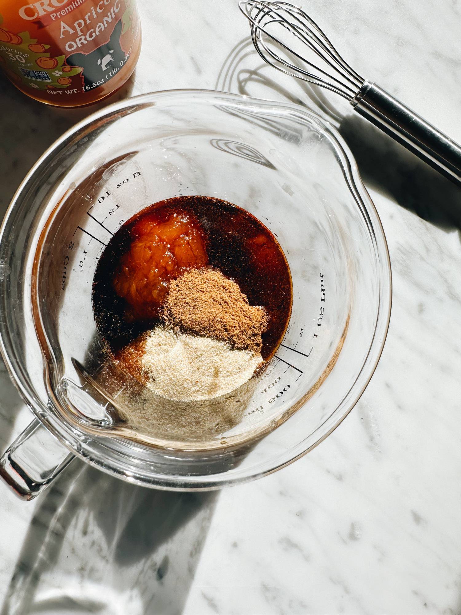 Apricot sauce ingredients in a measuring cup.