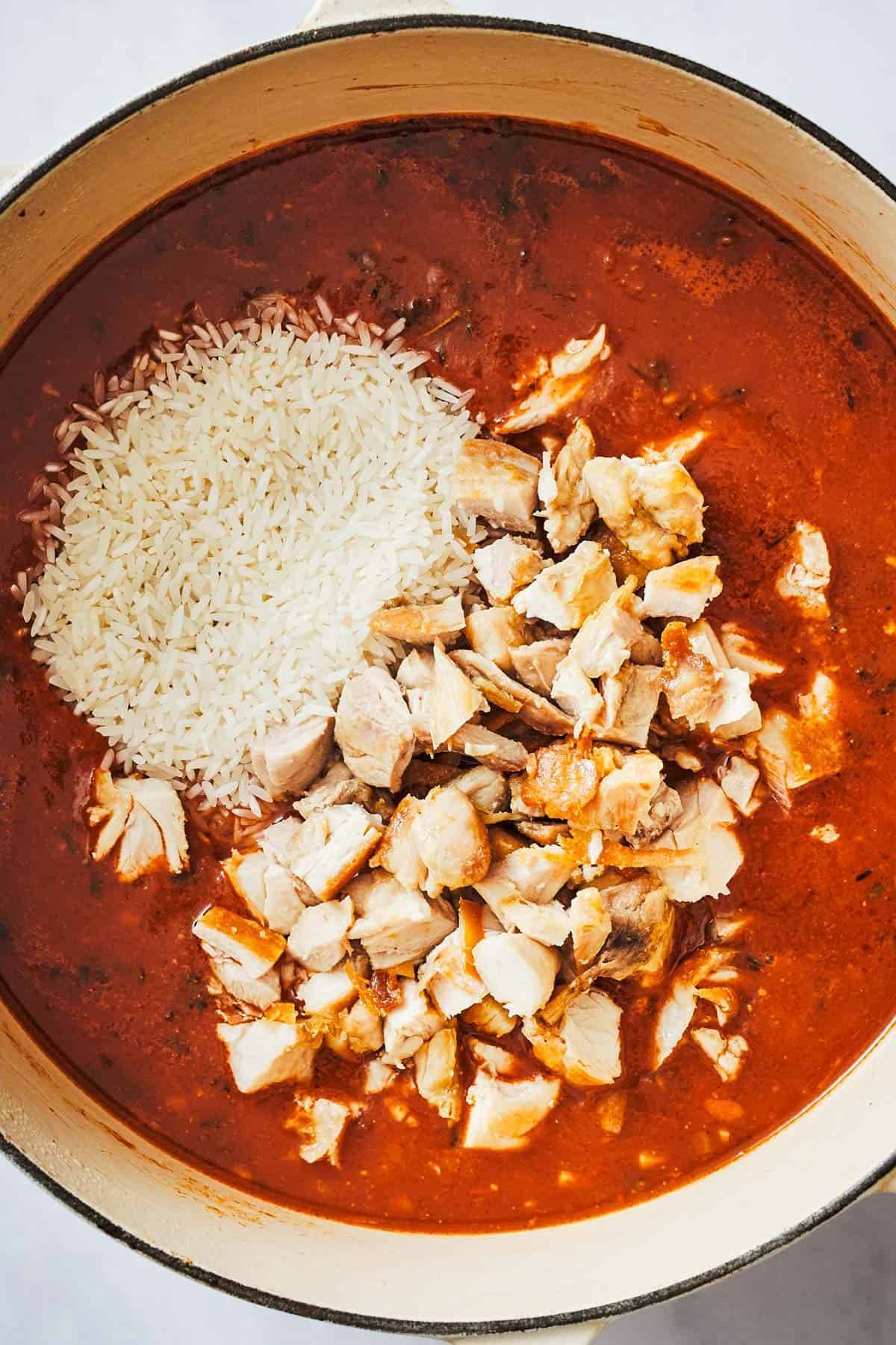 Ingredients for Arroz Con Pollo in a dutch oven.