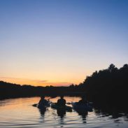 People canoeing at sunset.