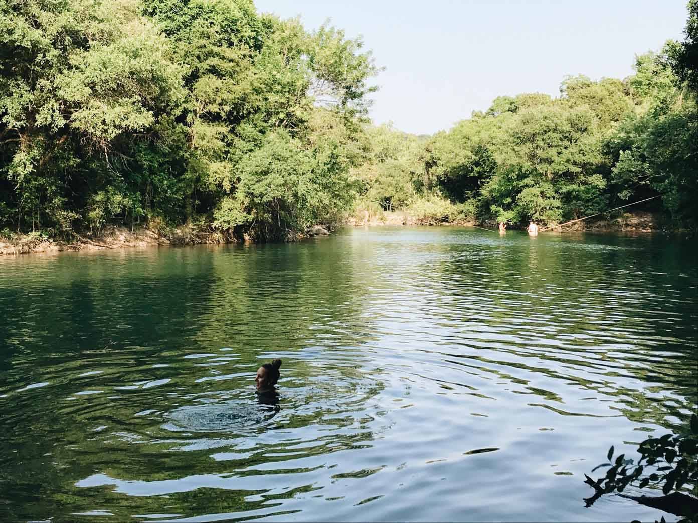 Woman swimming in a river.