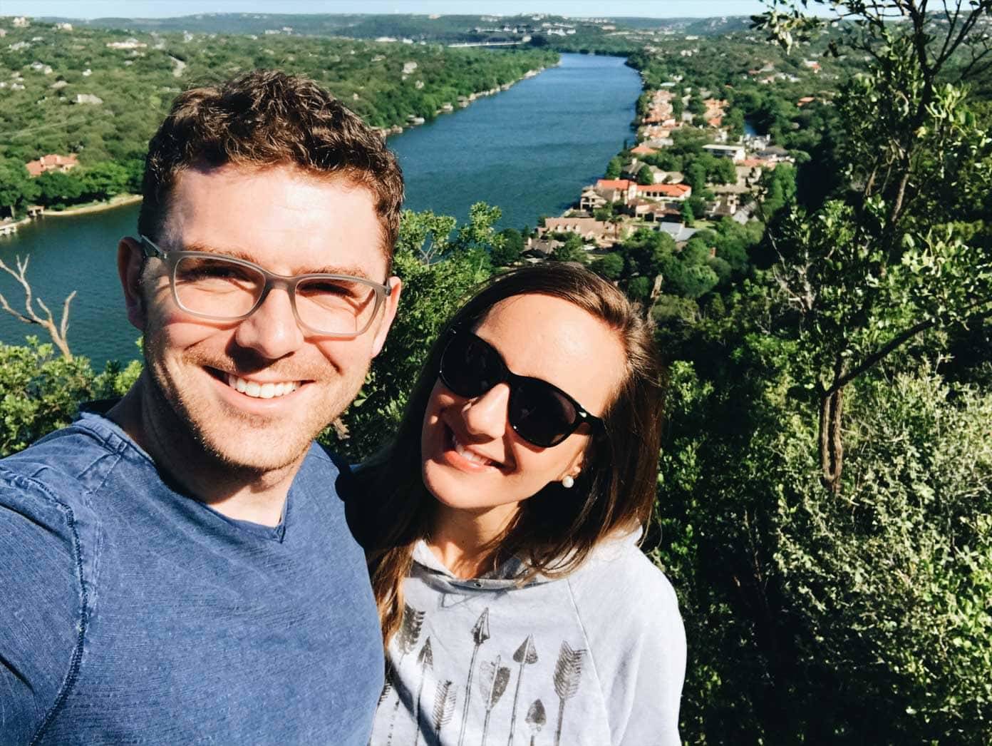 Man and woman standing in front of a large river.