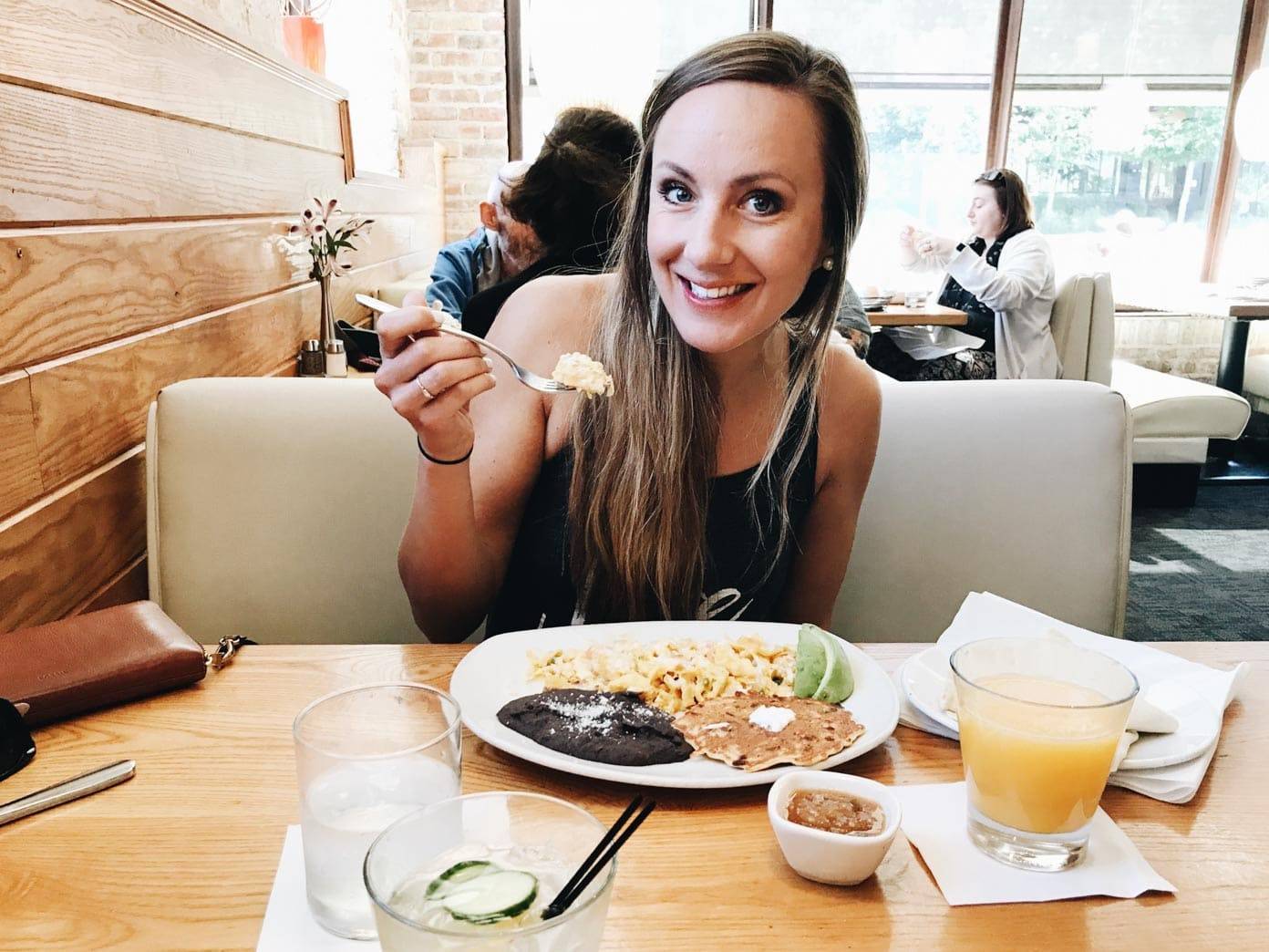 Woman sitting at a table eating.