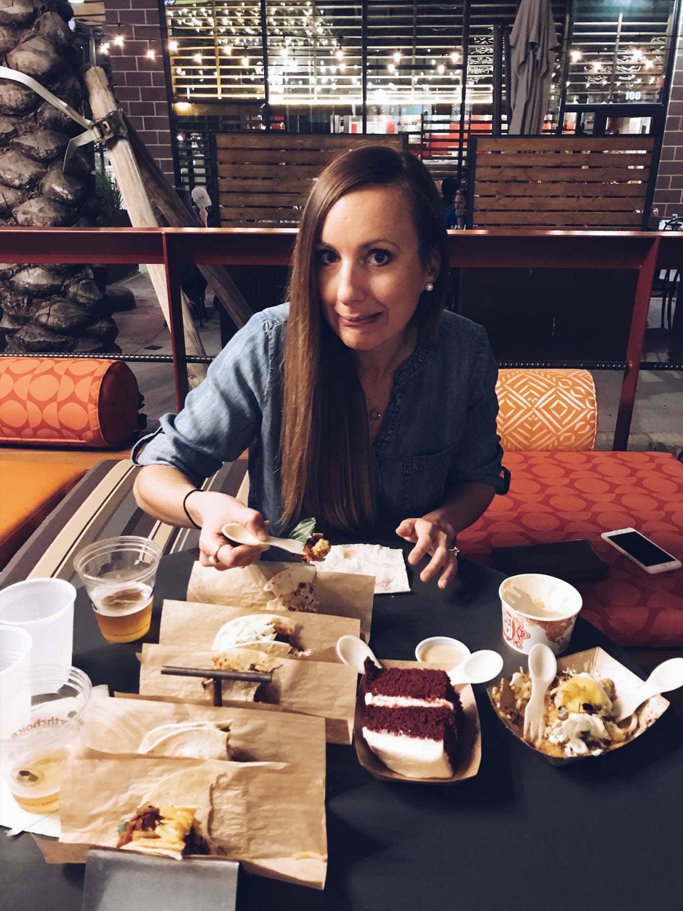 Woman sitting at a table in front of food.