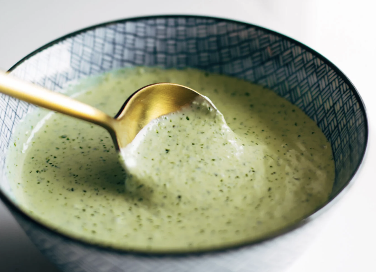 Mixing aji verde in a bowl.