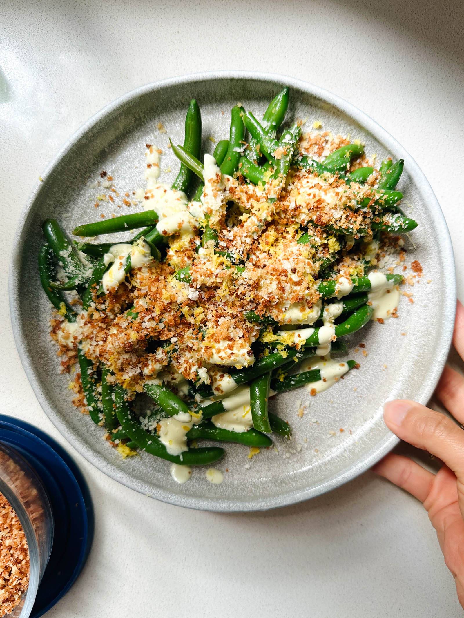 Caesar green beans on a plate with crispy panko.