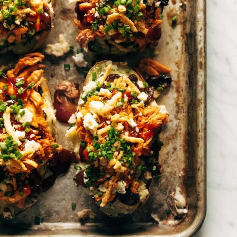 Loaded BBQ Baked Potatoes on a sheet pan.