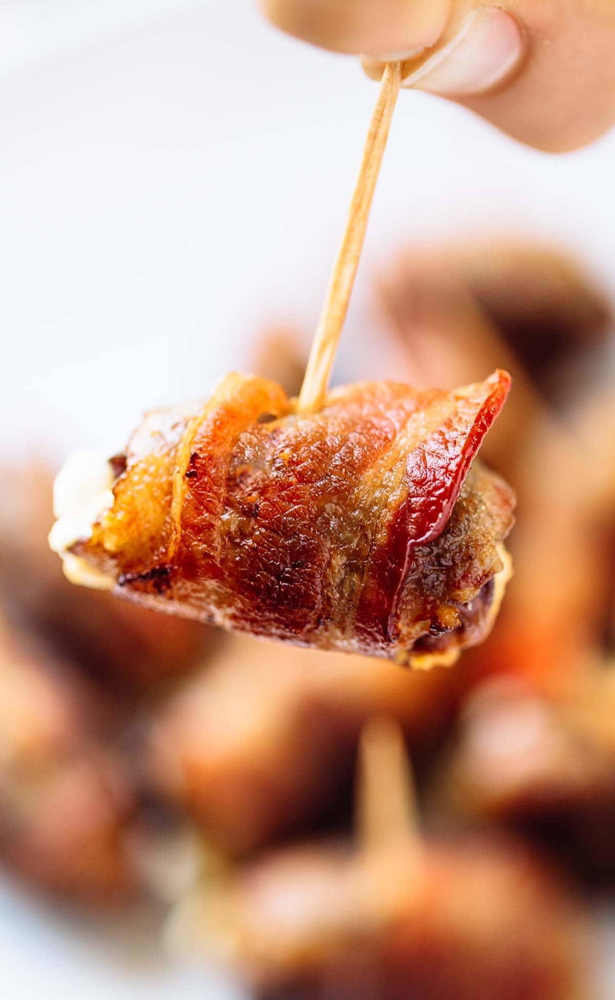 Bacon Wrapped Dates with Goat Cheese on a toothpick.