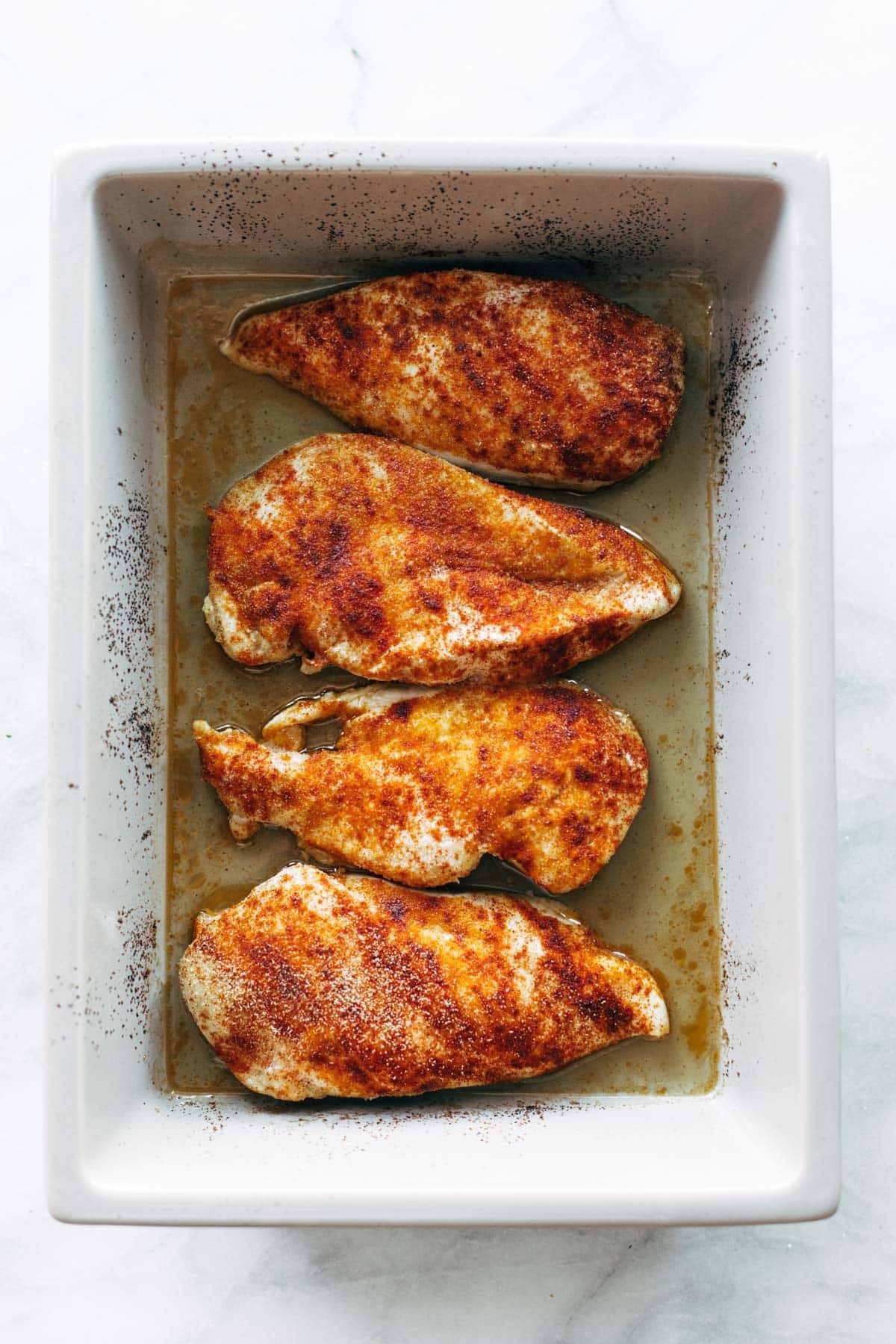 Baked chicken for paprika pasta in a baking dish.