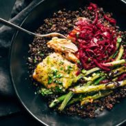 Baked Salmon in a bowl with lentils, green beans, and sauerkraut.