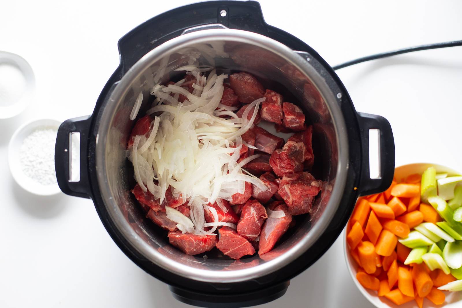 Beef and onions in an Instant Pot.