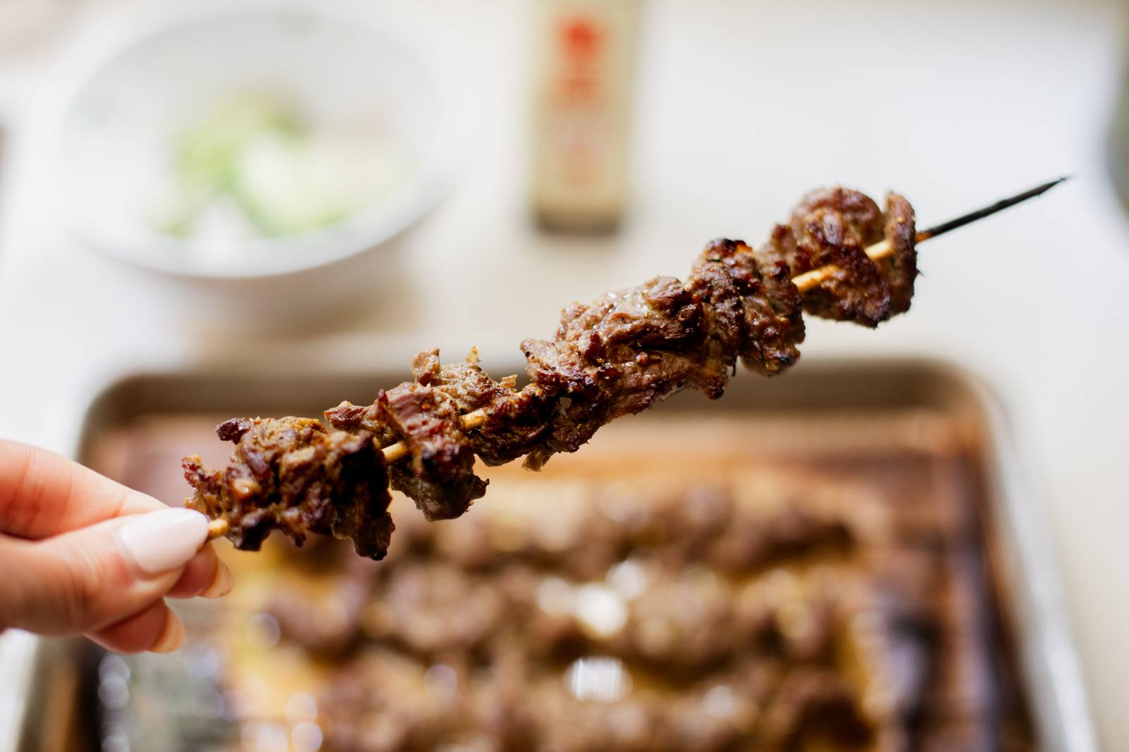 Crispy broiled steak on a skewer.