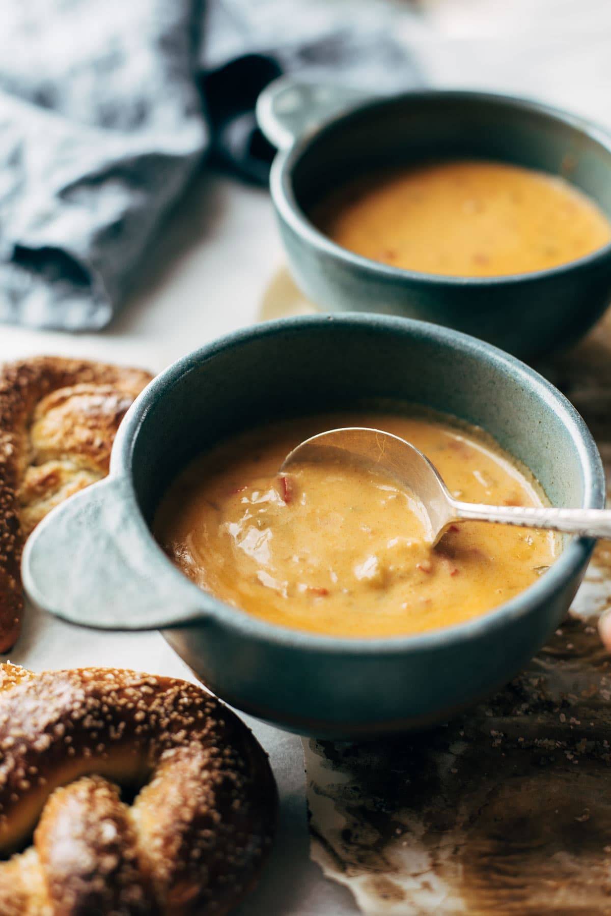 Spoonful of Beer Cheese Soup in bowl.