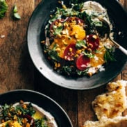 Beet salad in a bowl with whipped feta and garnishes