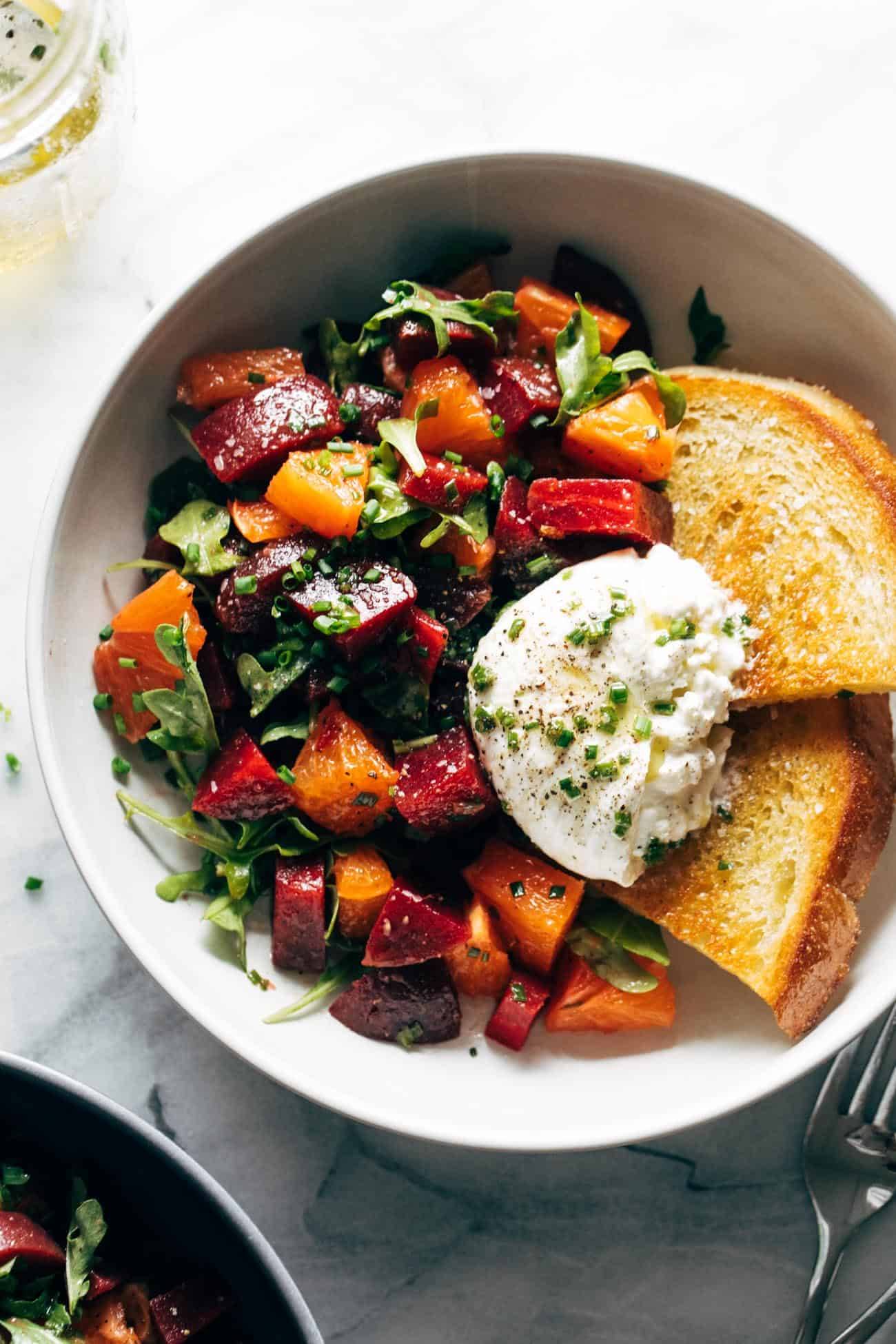 Beet and burrata salad in a bowl with fried bread