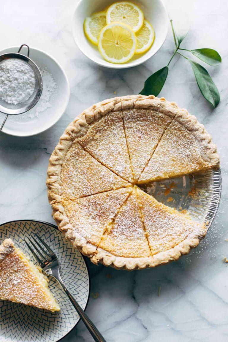 Lemon pie with slice on a plate.