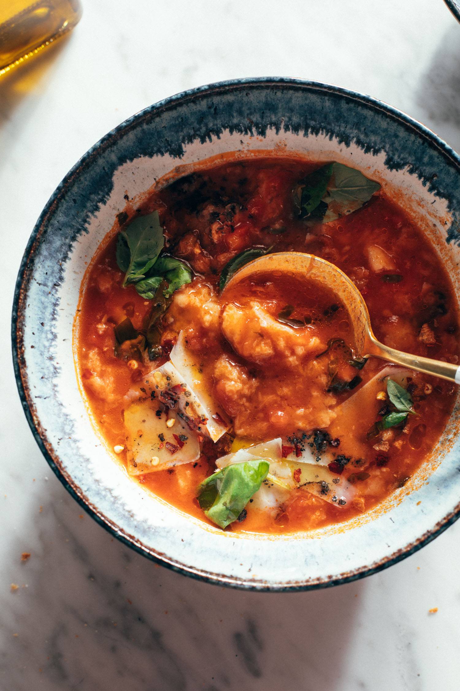 Spoon in bowl of tomato and bread soup