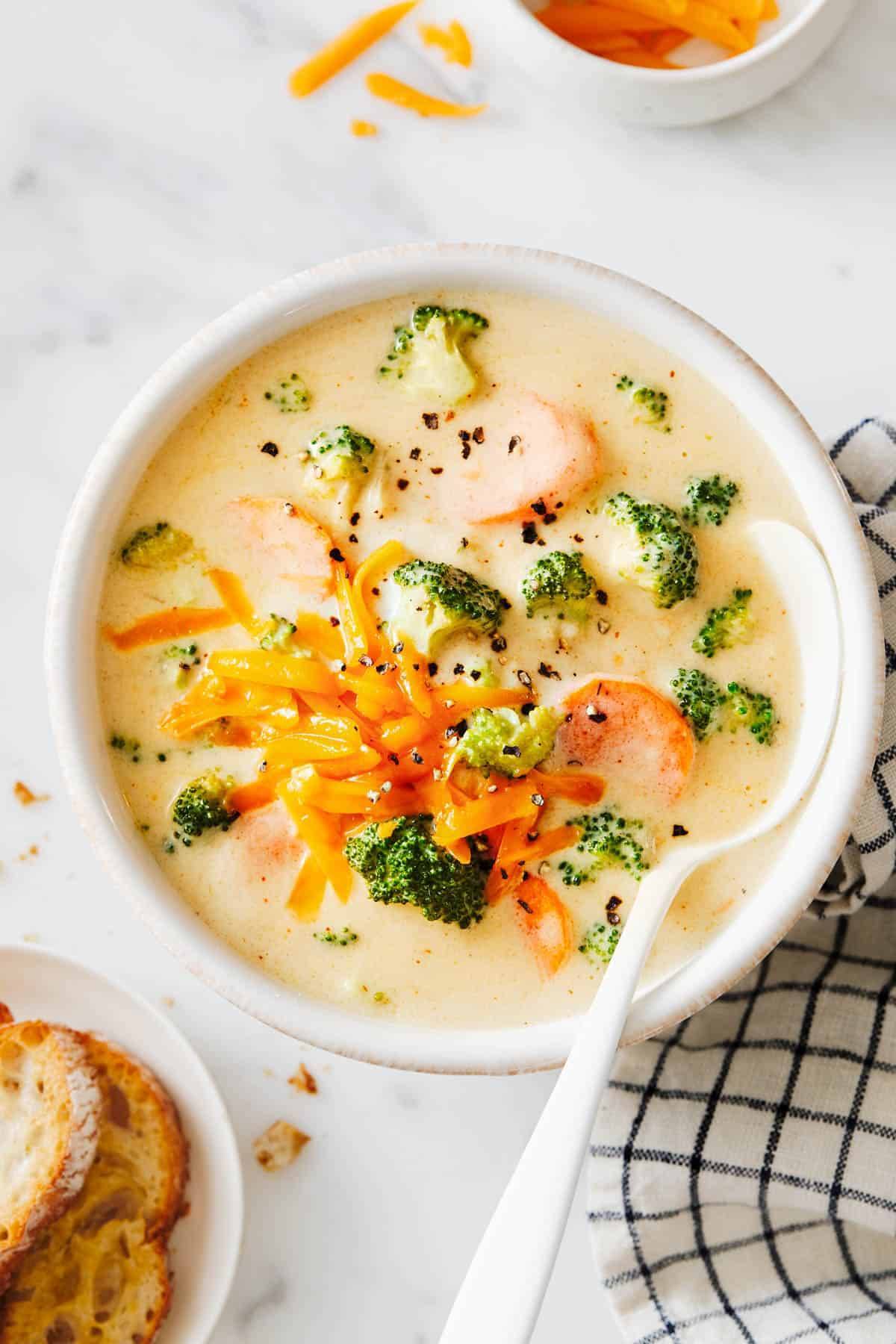 Broccoli cheese soup in a bowl with a spoon.