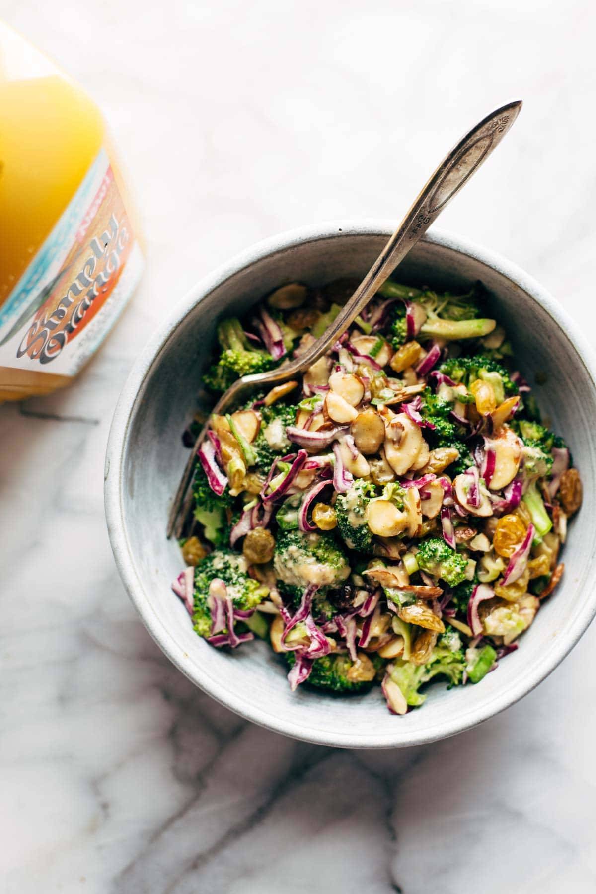 Broccoli salad in a bowl with a fork.