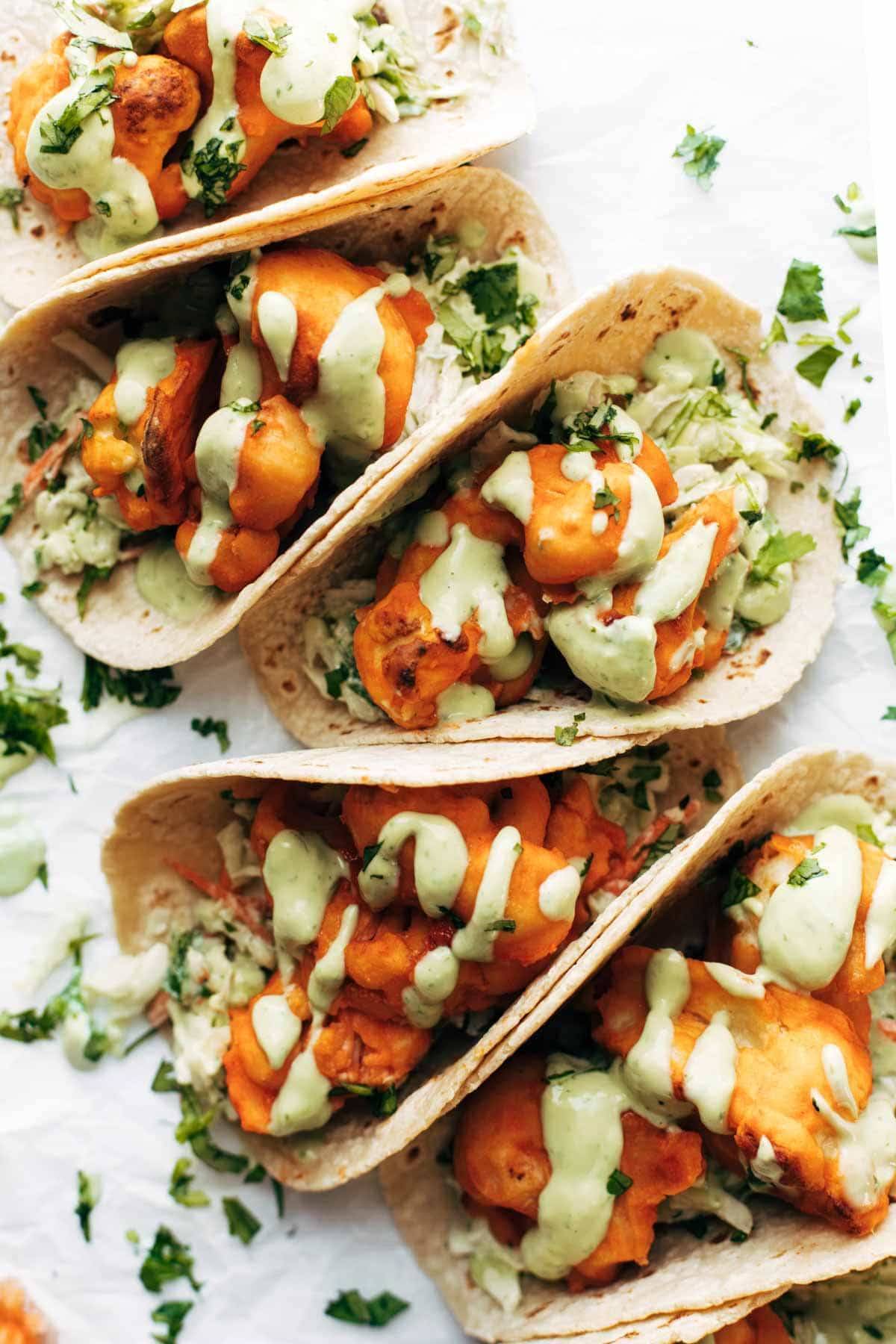 Buffalo cauliflower tacos with avocado crema.