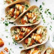 Buffalo cauliflower tacos drizzled with creamy avocado sauce.