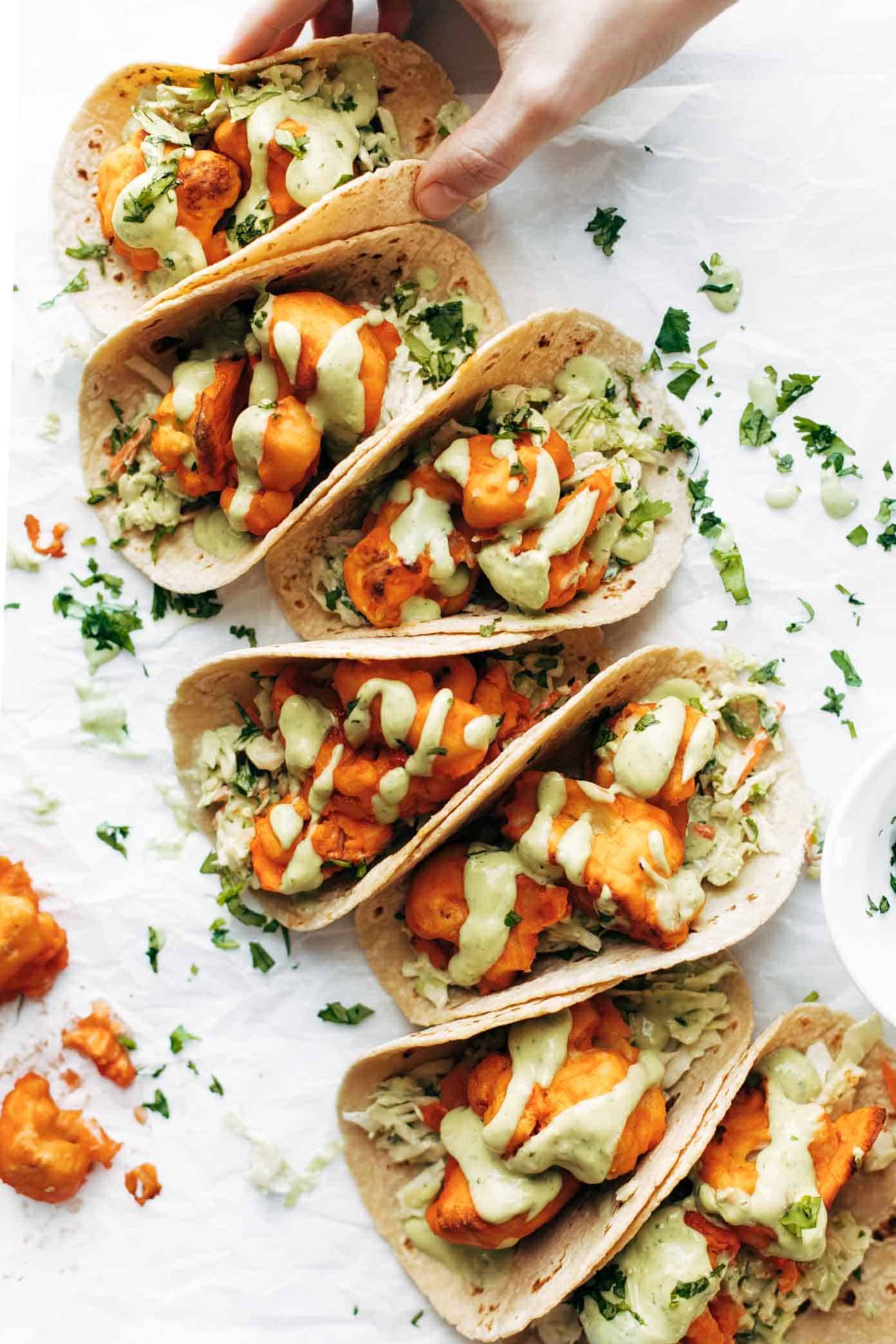 Buffalo cauliflower tacos with avocado crema.