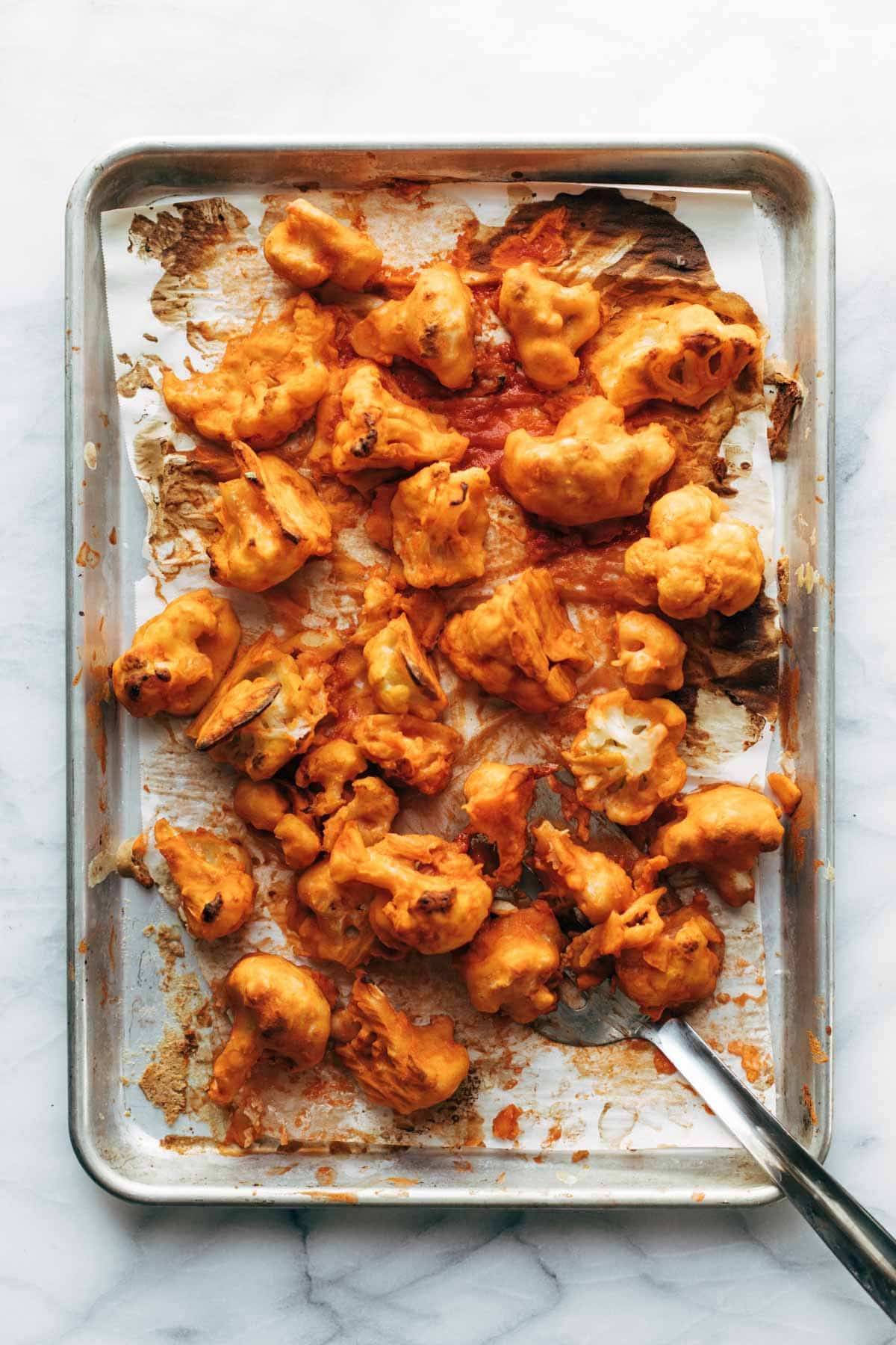 Buffalo cauliflower baked on pan.