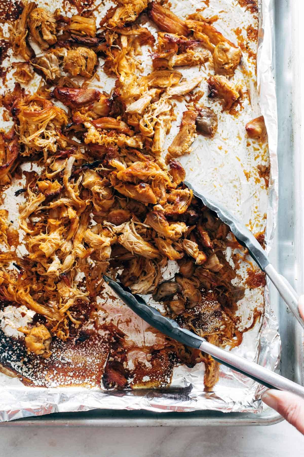 Crispy buffalo chicken on a sheet pan.