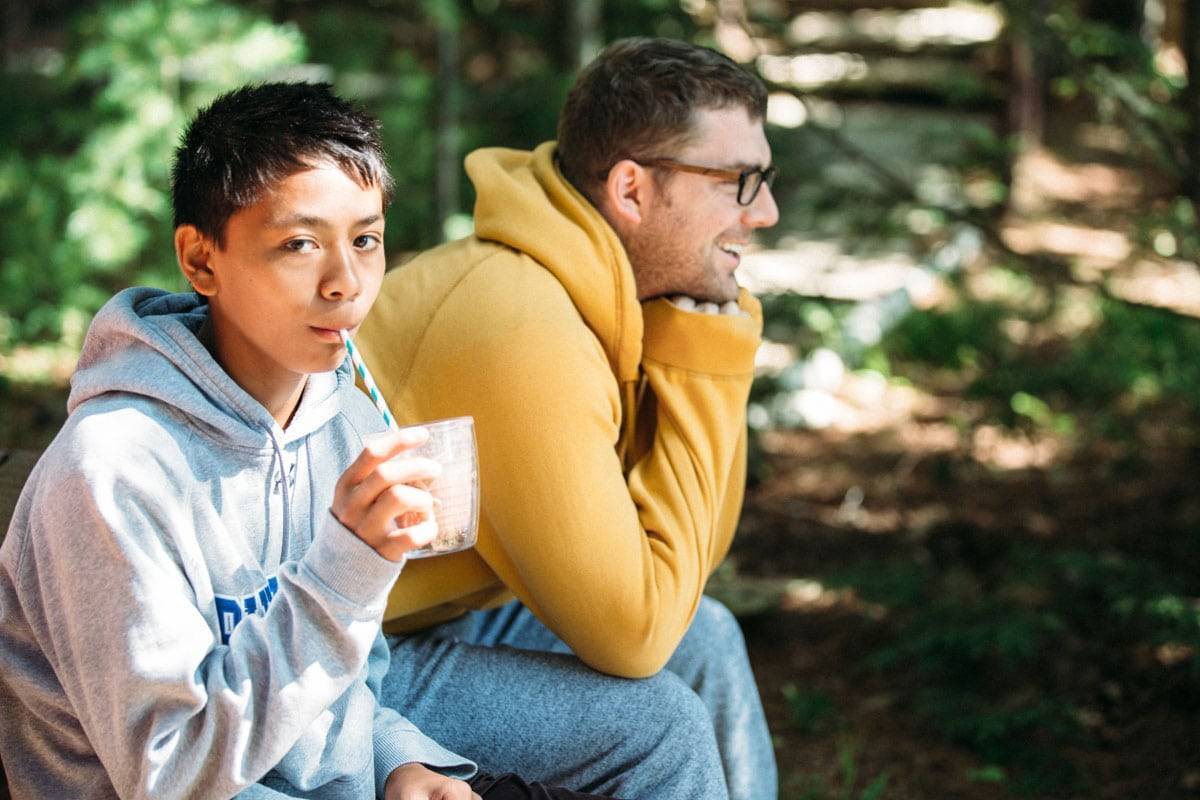 Young boy drinking from a straw.