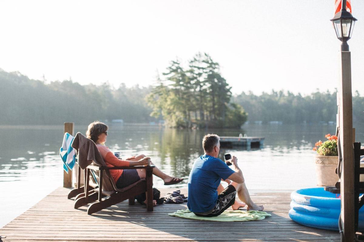 Man and woman sitting on a dock.