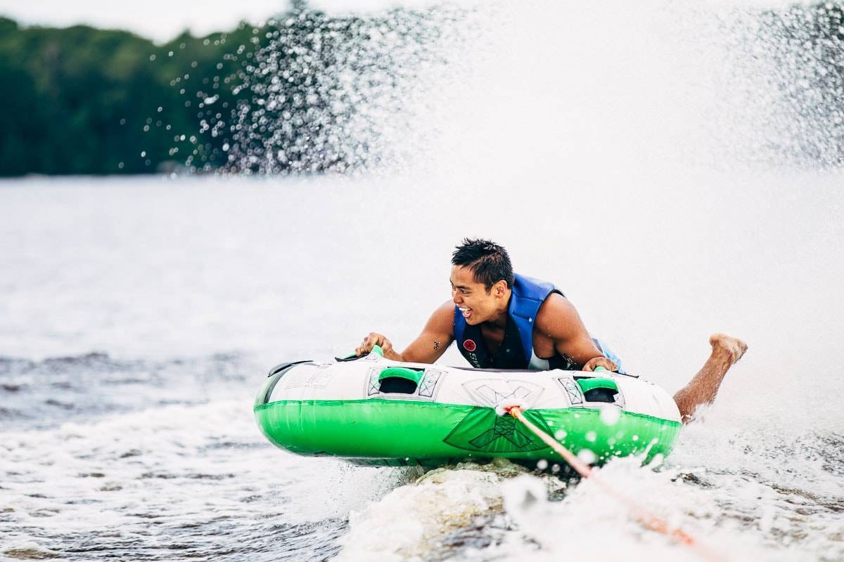 Boy tubing on the lake.