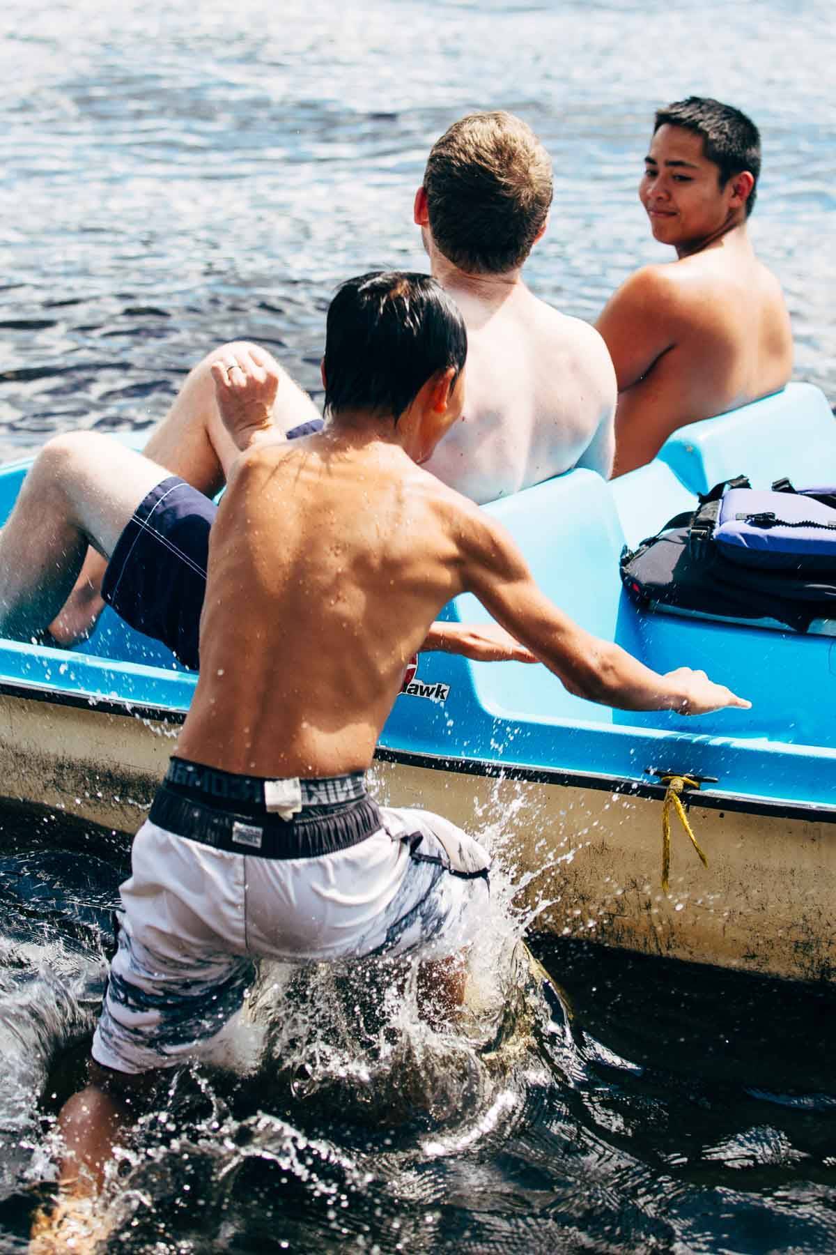 Boys on a paddle boat.