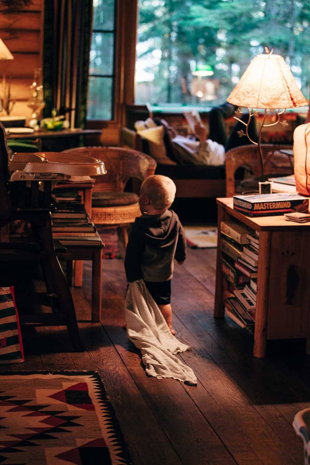 Boy dragging a blanket.