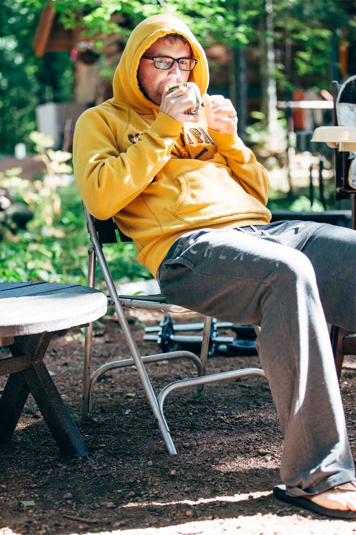 Man drinking out of a mug.