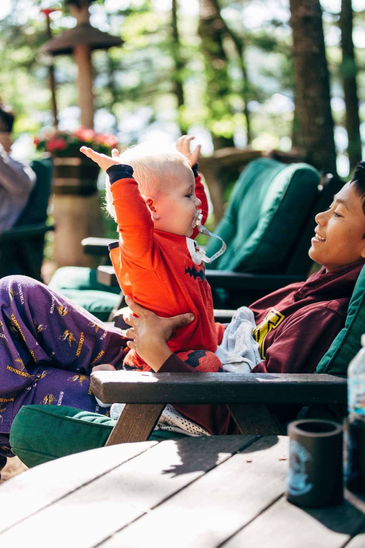 Boy holding a toddler.