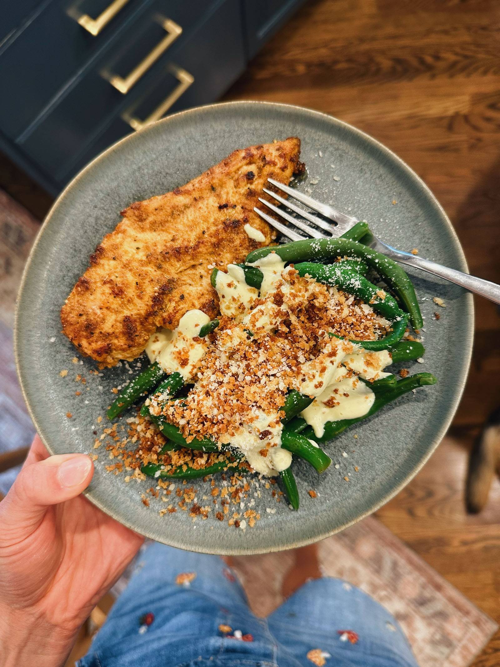 Caesar green beans on a plate with air fried chicken.