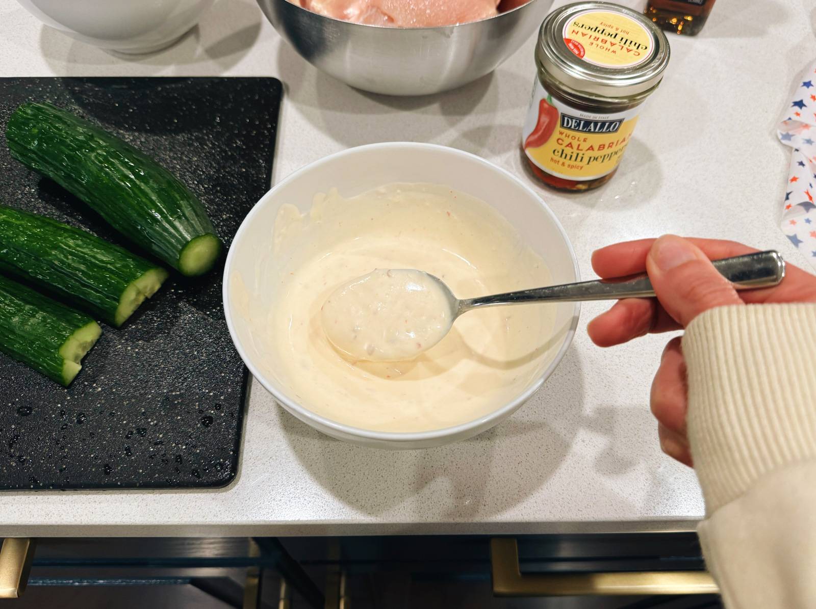 Mixing up a creamy calabrian chile sauce in a bowl.