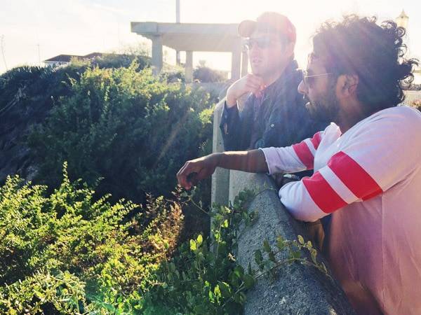 Two men on a bridge.